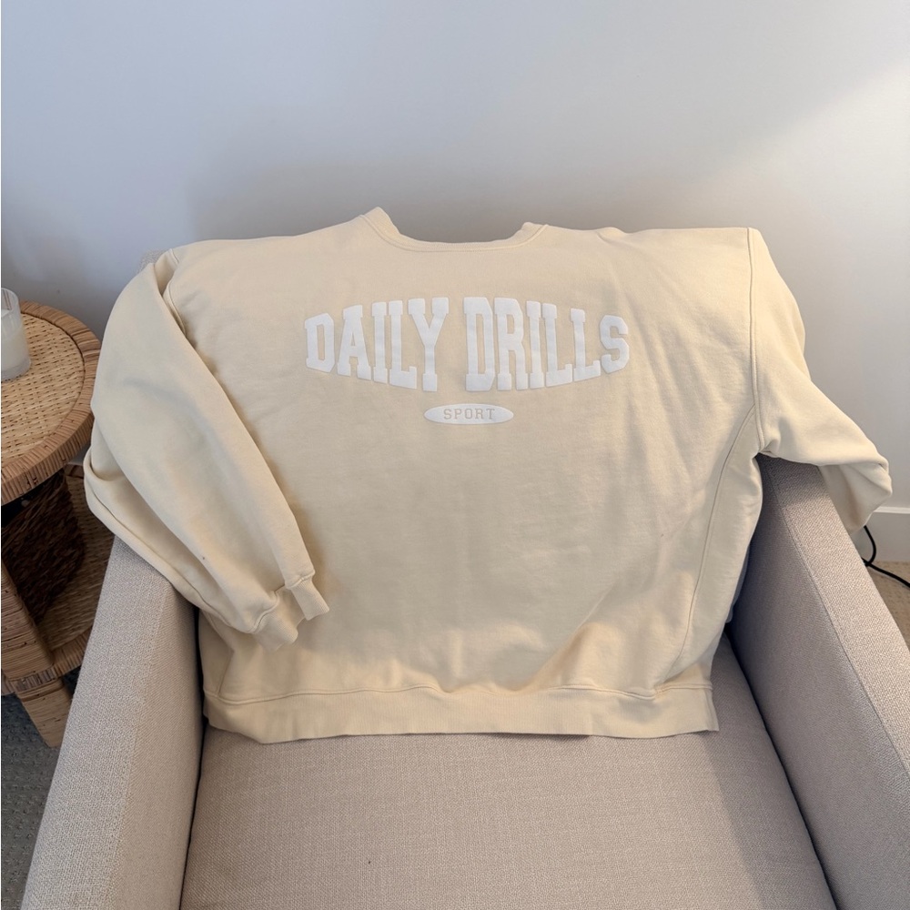 Daily Drills Cream Pullover with Green Logo